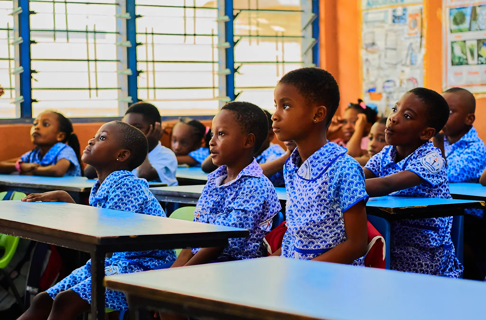 Pupils actively participating in a primary classroom lesson